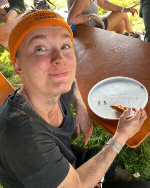 Amy James-Kelly Instagram - TOUGH MUDDER NORTH WEST 2023
••••
15km of mud, water, hills, and the wackiest obstacles since Richard Hammond and his Big Red Balls.
••••
Like Fall Guys, but real life, and you don't bounce if you fall. And you pay to do it. And you hurt for days after. And you run for way more than a couple of minutes. And there's no bright colours, it's all just grass and mud. So it's nothing like Fall Guys really. 
••••
I've been nervous about this for months - two surgeries later and I'm negotiating this event with a body that needs to do more than just train to run for a bit... There were obstacles I was on doctor's orders NOT to attempt (and I didn't, dw) But I conquered it. All 15k. And when I had to miss out an obstacle (like the two that electrocute you) I made sure I pelted it to the next one, just so no one could say I had an easy day of it 😜. We all crossed the finish line together, caked in mud, water, sheep shit, blood and sweat. And dya know what? I had a belting time. I have crap upper body strength so fell off every single set of monkey bars I crossed paths with (into the most horrible 'water'), but I did do two obstacles that triggered my claustrophobia so I'd say I redeemed myself...
••••
Matt, Will, Andy and of course Dan, who I absolutely not in a million years could have done this without, right from training to pulling me up the last few feet of that wall as I dangled from his arms. (And there's evidence within these photos that he had rather a nice time assisting me too, I guess... 😜)
••••
Can't wait to see the official photos from the event and be greeted by some ridiculous shots of me going arse over tit... @toughmudder