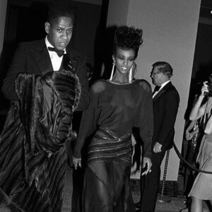 André Leon Talley Instagram - It was the golden age of style. Diana Vreeland's legendary Met show, in December 1983: Yves Saint Laurent's great l25 year retrospective.  I got to
escort Iman, who decided a giant mohawk was only fitting for her black couture Alaia dress. The dress was flown over from Paris, just for the evening. The inset panels had glitter that moved inside chiffon windows as she walked. Iman, decided to get dressed in my apartment, a small tiny, duplex at 1 Astor Place, downtown.
That was her floor length fur I am carrying, not mine. Iman's neck looked like a selfie stick. I think I looked like Jay-Z, a young Jay-Z.  The  couture dress went back to Alaia for his archives.
I remember Paloma Picasso showed up in couture  draped velvet by St.Laurent and Jacqueline de Ribes, in YSL plumes and velvet.  Style was different then. #thechiffontrenches #iman #vogue #themet #cfda #mondaymood #makeitfashion  #jayz #ysl #palomapicasso #alaia