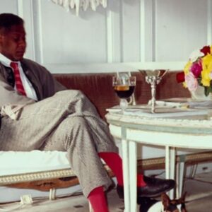 André Leon Talley Instagram - ANDRE; ALL IN.  HERE, ME THE SKINNY, IN MATSUDA, SWEATER, CHARVET SOCKS AND BROOKS BROTHER'S CLASSIC MOCS: Christmas mourning in 1989 at Karl Lagerfled's country estate Le Mee.
The furniture in the salon is rare 18th Century Italian, a settee with chairs. Of course, I lost my grandmother and Diana Vreeland, that year. So on Xmas eve, I went by Concorde to Paris, was shuttled off by car, Briam, (he was the chauffeur then) and Karl hosted me for two weeks, into January.  Karl had also lost the love of his life, Jacques de Bascher earlier that year, so we both mourned.  He was never seen before lunch, (often and frequently served at 4 p.m.) and everyone was served breakfast in bed.  We  changed clothes,and dressed to the moral codes of dress of our host.  Food was superb, personal service, out of this world, next level quality.  Diptyque candles were lit in every room, and burned all day. Saffron yellow Porthault towels were abundant.
Linens were changed every single day.  There was a hidden staff, I never saw the staff until dinner was served or when they came with my breakfast tray.  If lunch was at 4 in the afternoon, then dinner might happen at  9:45 p.m. and last until the early hours of the morning.  Karl once loaned me the sofa that I am seated on, but he made sure he asked for it back  when I returned to New York in 1995.  Karl was that generous. He would lend you rare suites of furniture and then ask for them back.  The flowers in a fresh wicker basket were from Moulie Savart, where Karl spent fortunes for years. The best florist on square Palais-Bourbon, just a door down from Vogue's Paris office.  I loved Karl's sense of luxury, and he always sent his favorites huge wicker tubs of flowers.  #karllagerfeld #paris #chanel #diptyque #mouliesavart #chanel