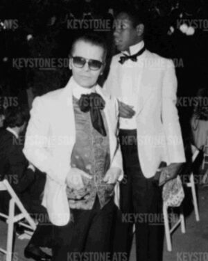 André Leon Talley Instagram - It’s Kaiser Karl (Lagerfeld) and Andre (the tall skinny beanstalk (Leon Talley) in 1977, at the legendary wedding ball of the late @ysl muse, Loulou de la Falaise, to Thadee Klossowski.  Paris, on the ile du bois, a special evening where I flew over to Paris, and Karl and I went together.  We were on the official list of invited guests sent out by the house of YSL.  Karl's love of his life, the late Jacques de Bascher was not invited. He caused the complex rupture of friendship between Karl and Yves. He dangled his dazzling sexual chemistry on a tightrope in front of Yves; and Karl seemed amused by it all.  
Lagerfeld and I were in our second year of friendship. When we met, through Andy Warhol, in May , 1975, we got on like fireworks in a spectacular display.  Lagerfeld was way ahead of everyone, even then, we climbed into
a high Range Rover as a  luxury sedan to go to the ball, which lasted until dawn.  Lagerfeld, resplendent and I, in a hand me down custom made Halston white dinner jacket, and a cotton kerchief carrying my evening stuff, ( a comb and a mini camera) to catch the likes of Bianca Jagger , in a Zandra Rhodes crinoline, where Yves
stood her against a wall and decorated with fresh palm fronds, or where I missed all the decadence, going on, on the outer edges (drugs, sexual dalliances! hetero and homo).  I flew over coach to Paris, and stayed in
the late Joel LeBon's flat where Picasso once lived.  Tina Chow, came over for the wedding , wearing her favorite Fortuny silk dresses wrapped around her throat as a muffler to the gay Club Sept. What was so wonderful about going out with Lagerfeld in 1977: he was a rising star in the fashion galaxy, designing for Chloe, the luxury ready-to-wear French house and Fendi. I was on a fast track , speed dial, tutorial learning everything from Karl about Eighteenth century France: style, art,
design, fashion, arts de vivre.  Everything about Karl was exceptional, and elegant.  There was nothing seedy, or vulgar, nothing perverse, then or ever, during our near four decades of friendship.

Those were the great days of my youth. #wwd #thechiffontrenches #karllagerfeld #vogue #dvf #andywarhol