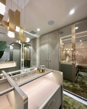 Andrés Mercado Instagram - This  Master (piece) Closet, delivered by the best @ornaremiami in suede, and gold mirrored doors, beautiful leather island, and more exquisite details when you swipe. Adding to this elegant space we have the wonderful @leebroom with his signature pendant light. This Master closet was fully  covered on a light green-goldish wallpaper, to continue this green conversation with the super comfy silky rug, as usual, @lafloreria.atelier adding elegance to the space next to this neutral white art pieces, and beautiful accessories thanks to @jonathanadler