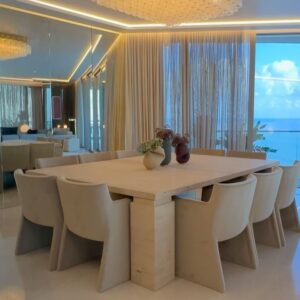 Andrés Mercado Instagram - Dinning in heaven starts with uninterrupted ocean views and off course this chic art piece from the most important Colombian artist of all times, Fernando Botero. Along this perfection we customized an oversized  marble table in travertine and add some softness with the velvet chairs, we can not missed the flower arrangements by @lafloreria.atelier on top of the Vanitas Set Rubber Vase by studio b severin Germany, under the light of this majestic 1960s flush mount thanks to @1stdibs .