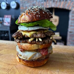Andrew Rea Instagram - Binging is back baby!! To celebrate, I proudly present the Every Burger. Inspired by the brain-melded creation of Rick and Jerry in the new season of @rickandmorty, it’s 8 different styles of burgers in one: a dry-aged, Hawaiian, jucy lucy, bacon, Cuban frita, animal-style, good-morning burger on a potato-brioche bun. Live now, link in tree!