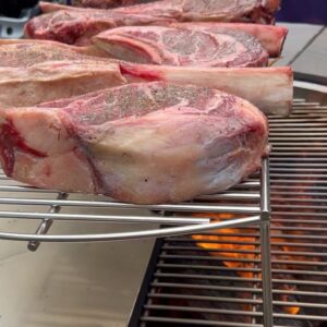 Andrew Zimmern Instagram - Summer BBQ perfection baby chickens, dry aged beef, @gathergrills @foguestx allows us to cook effortlessly for 90 ppl. All over open fire.
Lemon/rosemary/olive oil on the chicken. Salt and pepper on the beef.