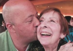 Andrew Zimmern Instagram - That’s me kissing my mother Caren Zimmern who was born Clara Betty Heyman in 1929 although her whole life she told everyone it was 1935. Look at how joyous she was in that picture. Why?
Because by that time in her/my life she wasn’t worrying about me anymore. 
The first 40 years of my life she was pretty damn worried about me all the time! 
The first 14 years it was the natural worry of a mother, the next 14 years i worried a lot about her (she was very ill and remained so for the rest of her life) and then despite her wellness challenges and all that it brought her she had new worries for me as I was drinking and drugging my way through life.
Until i became a parent myself 19 years ago i had no clue as to the burdensome depths of worry I was to her. Mothers even more so than fathers are hell bent on insuring their children make it out of the nest and fly on their own. It took me about 40 years to get it together. 
I owed her such a debt for all the lies, the stealing and worry, that I moved her from NYC to Minnesota in the later years of her life so that I could care for her a little bit more and so she could be closer to her grandson. Despite her fragility and other aging issues, I think those were some of her happiest years. 
I have regrets in life that nothing can erase. I’ve learned to manage them so they don’t overwhelm me but a big one revolves around the question of “what I could have done differently” for my mother. 
This picture reminds me of the simplest truth. I hadn’t bought her anything that day. I hadn’t done something specific to make her proud, there was nothing going on here except kissing her cheek visiting her home. But that’s all it took to make her so happy, because there was nothing for her to worry about. 
How we make people feel is the secret sauce of life. The tie that binds. My mother always loved me unconditionally despite all my shortcomings and I think about her all the time, especially on days like these. Happy Mother’s Day to all the moms and for anyone who struggles with this day, I get it. Go do something for another human being, get out of your own head. That’s what I’m doing. It would have made my mom really happy.