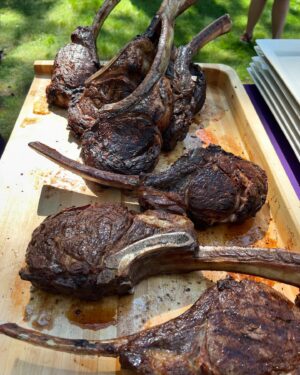 Andrew Zimmern Instagram - Summer BBQ perfection baby chickens, dry aged beef, @gathergrills @foguestx allows us to cook effortlessly for 90 ppl. All over open fire.
Lemon/rosemary/olive oil on the chicken. Salt and pepper on the beef.