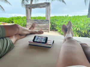 Anita Corsini Instagram - Still celebrating @kencorsini birthday from last week … nothing stops him from watching the game 😆 … not even a cabana in Mexico 
🐾🏈❤️🖤❤️🖤🏈🐾
