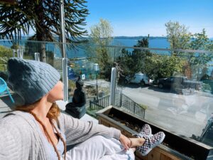 Anne Leighton Instagram - I got the ocean right at my cherry checkered feet 
Down round this lil town 
there’s a beanie wearin’ springtime beat
Perched high above like a bird gazing out to sea 
Rays of sun rest 
onto this nest 
built stick by stick named you and me-
🎶🍒☀️#my #cherrysunshine #home #ocean #view #poetry