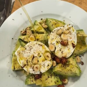 Annie Starke Instagram - Was craving something with avocado and wouldn’t ya know it… I found some burrata. Topped errythang with Spanish olive oil, orange vinegar, smoked s/p, sumac   toasted hazelnuts for cronch. 

10/10 no notes.