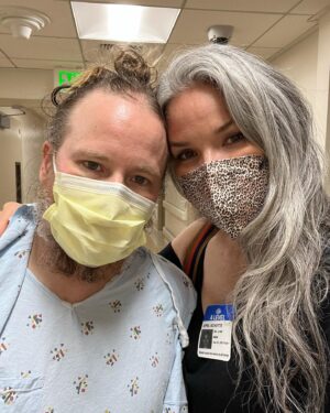April Schutte Instagram - Shawn is home! Home with us and recovering ❤️‍🩹 This was the hardest and worst week ever…One week ago, Wednesday evening we went to the ER because Shawn had extreme stomach pain that wouldn’t stop and kept worsening. Hours of waiting lead to them finally diagnosing him with appendicitis (I had assumed this hours before but we were hoping it was food poisoning). They decided they needed to do surgery the next day and in the meantime kept pumping him full of antibiotics and pain meds (which did nothing the first day!) They then kept pushing his surgery back and as the time passed, his pain and swelling got worse and worse. They finally went in and his appendix had perforated just as they were starting to remove it! Once in recovery, there were some minor issues that are too gross to mention…then on the other side of surgery, there were SO many things that kept happening to make this a lot more challenging (and painful) than the average appendectomy. His organs were “dormant” and wouldn’t wake up and function properly…his belly bloated up so badly, causing even more pain, he couldn’t even keep water down without painfully vomiting because of extreme heartburn. It was so hard to see Shawn like this and to leave him there…Grey and I went to visit every day, twice a day. It was hard to find help as everyone has their usual routines and responsibilities, but Grey was a model visitor and the nurses all looked forward to seeing him. They were amazing. A time we were able to get help, and we are so grateful. @ghoulygrrrl and her family took care of Grey for one of the days when I needed to work a modeling (that’s a whole other ball of stress I’ll get into later!) They took him into their home and gave him so much love! Well…I meant to make this short…just so fucking grateful that my love is healing and getting better each day. With that, my anxiety is slowly starting to relax a bit…and one more thanks to all of our friends and family who texted every day! We love you 🖤 And to my lovely clients, I will get you on my books ASAP! (Last 2 photos are from today! We all got out for a slow walk on this beautiful day and had some vegan ice cream)