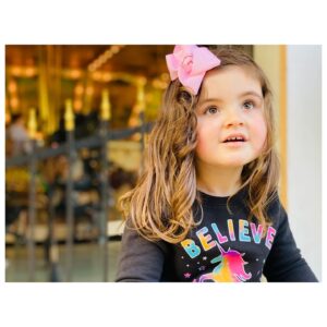 Ashlynn Yennie Instagram - This Girl 🎀 She wears bows now! 🎉 This is HUGE as she hated having anything on her head, PTSD from wearing a helmet for seven months to correct her Plagiocephaly. She has a flat spot on the right side of her head due to her torticolis, when I say she’s been through a lot … it’s no joke. She would only let me wash her hair and brushing was never an option. Well, through LOTS of practicing on her dolls and barbies and putting a clip in for 5 seconds, then a minute and so on … we now brush our hair and wear clips & bows! 🎀 My momma heart is happy happy. #consistencyiskey #autismawareness #autismmom #nevergiveup #bows #girliegirl