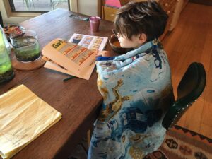 Audrey Marie Anderson Instagram - His favorite way to start the day. Wrapped up in his dad's old Star Wars blanket reading Garfield.