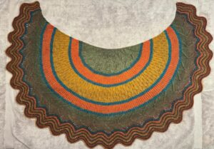 BD Wong Instagram - Alternate view of the latest @westknits project, the #knitprovisationshawl. Always really fun to give it its first bath and lay it out flat. I made this with @lionbrandyarn's #mandala yarn in the colorstory #Groot. I cut up the various self-striping sections and used them separately so it's really #lionbrandyarn that did all the heavy lifting picking out the colors.  I don't always do it that way but I wanted to see how that would work and I like it. If you're color-phobic you don't have to be! Also, don't be color-phobic! I had to make a few adjustments (sections 1 and 5 should be the same gray-green but I ran out so I had to sneak in a gray-plum color, and I also had to use multiple alternating colors for the final wavy stripes for the same reason) but hey, sometimes when one door closes a window opens. This one didn't take long at all. I like the "stitch sampler" vibe of it.