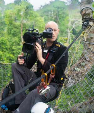 Bertie Gregory Instagram - #CanopyCampLife! Our rope experts @waldo_etherington and @meg_and_onaldson rigged this tree house allowing us to film, sleep and eat high in the trees as the elephants went about their business underneath us. Due to a long history of poaching and their thick jungle home, forest elephants understandably get very grumpy when they bump into humans. So by staying off the forest floor, we could film while the elephants did their thing undisturbed. Also featured in these pics is director @markmcc01 and sound recordist @justdrewsound. 

Many people seem to be very curious as to how we went to the bathroom. It involved a bag, good balance, good aim and careful positioning of the climbing harness straps! Supporting us in the trees, we owe a huge thanks to the local team who put in some serious heavy lifting helping carry in and out the jungle all the ropes, filming platforms and hanging tents. More on them soon! Photographed in @dzanga.sangha National Park for the ‘Elephant Quest’ episode of ‘Animals Up Close’ now streaming on Disney ! #AnimalsUpClose @wildstarfilms @natgeotv @remote_ropes_ltd