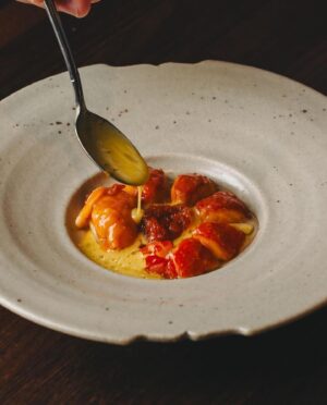 Björn Frantzén Instagram - Grilled marron, fermented carrot and curry condiment, saffron beurre blanc with lime @restaurantzen.sgp