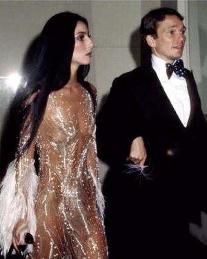 Bob Mackie Instagram - Cher attends the Met Gala in 1974 with Bob Mackie, wearing one of his iconic designs #MackieMagic 

#Cher #BobMackie #MetGala #MetBall