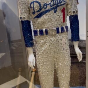 Bob Mackie Instagram - Bob Mackie recreated his iconic baseball cap design for @eltonjohn’s last dates in the US at the Dodger Stadium. 

Bob designed the original costume for Sir Elton’s concert at the stadium in 1975, and it went on to become one of Elton’s most memorable shows. Read the full article in @voguemagazine 

📷 : Ben Bentley / Rocket Entertainment
.
 #MackieMagic #EltonJohn #EltonFarewellTour #EltonLive