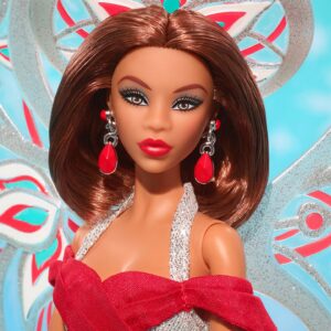 Bob Mackie Instagram - Thrilled to share that Bob has partnered with @mattelcreations to create a limited edition Barbie®️ Doll. The Bob Mackie Holiday Angel™️ sparkles like starlight in a floor length shimmering silver gown and a bright holiday red sash completes the look. Glittery wings soar behind her, while drop earrings and stacked bracelets, enhance her celestial sparkle.

The doll drops on November 9th at 9am PST. Link in Bio. Don’t miss out! #PaidPartnership
