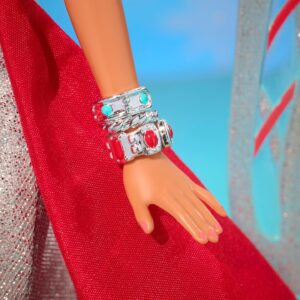 Bob Mackie Instagram - Thrilled to share that Bob has partnered with @mattelcreations to create a limited edition Barbie®️ Doll. The Bob Mackie Holiday Angel™️ sparkles like starlight in a floor length shimmering silver gown and a bright holiday red sash completes the look. Glittery wings soar behind her, while drop earrings and stacked bracelets, enhance her celestial sparkle.

The doll drops on November 9th at 9am PST. Link in Bio. Don’t miss out! #PaidPartnership