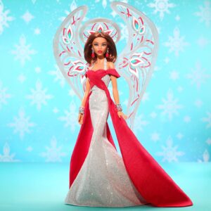 Bob Mackie Instagram - Thrilled to share that Bob has partnered with @mattelcreations to create a limited edition Barbie®️ Doll. The Bob Mackie Holiday Angel™️ sparkles like starlight in a floor length shimmering silver gown and a bright holiday red sash completes the look. Glittery wings soar behind her, while drop earrings and stacked bracelets, enhance her celestial sparkle.

The doll drops on November 9th at 9am PST. Link in Bio. Don’t miss out! #PaidPartnership