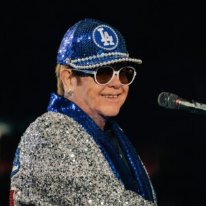 Bob Mackie Instagram - Bob Mackie recreated his iconic baseball cap design for @eltonjohn’s last dates in the US at the Dodger Stadium. 

Bob designed the original costume for Sir Elton’s concert at the stadium in 1975, and it went on to become one of Elton’s most memorable shows. Read the full article in @voguemagazine 

📷 : Ben Bentley / Rocket Entertainment
.
 #MackieMagic #EltonJohn #EltonFarewellTour #EltonLive