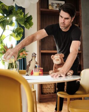 Brian Patrick Flynn Instagram - Most people, “I do XYZ for work.” Me, “Okay so today I moved a Tyrannosaurus rex, a teddy bear, and some wooden blocks back and forth on a breakfast nook table for about 45 minutes before pouring three glasses of orange juice in an odd numbered grouping at slightly different levels, wrote on a chalkboard and erased it six times, and then added in a skateboard and a time-telling robot to create a familial, kid-inclusive look but then it felt kinda not right so I colored in a book with some crayons and left them on the table, and then KAZAM! an hour later we took this photo, and I know that sounds absolutely NOT normal but it’s legitimately my job.” 🤷🏻‍♂️🏡💐🥛🦖🧸📸 @josephgbradshaw @charlieklaesius
