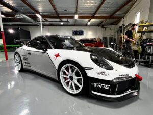 Bryan Craig Instagram - The best and my favorite performance brands came together to help me build my dream @porsche GT3. And a special thank you to @aero_werkz for the wrap/livery work and installing all the new parts and making sure everything was perfect and done to the highest quality. Another special thank you to @houseautomotive for getting the car corner balanced and aligned and dialed in. If you’re building a performance car and are wondering what brands to use … here they are 

Titanium Exhaust - @ipeofficial_ 
Magnesium super light wheels - @ipeofficial_ 
3 way adjustable coil overs - @nitron_suspension 
Racing seats - @recaroautomotive 
Racine steering wheel with controls- @kmpdrivetrain 
Cold air carbon intake - @armaspeed_official 
Carbon fiber RS hood - @darwinproaero 
Lightweight lithium battery - @antigravitybatteries
Roll/Bar cage - @studiorsr 
Wing upright risers - @suntiger115 
Sim rig for home track practice- @podium1racing 
Racing suit/gloves/shoes - @alpinestars 
Wrap- @inozetek 
Shop for the work - @aero_werkz 
Only car you’ll need - @porsche