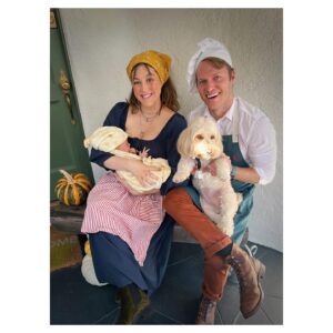 Caitlin McGee Instagram - 🎶the cow as white as breastmilk🎶 
HAPPY HALLOWEEN! 🐮🌽🩸👡✨🫘 
.
.
.
Just a baker, his wife, milky white and the loaf of bread that took 9 months to bake 👩🏻‍🍳🍞