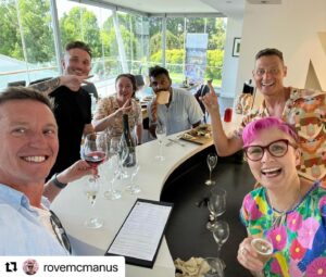 Cal Wilson Instagram - An excellent time had by all. Such a beautiful (and delicious) spot at @josefchromywines, and such a fun @grapesofmirth gig. Thanks for looking after us so well!

(Image: jubilantly smiling comedians gather round a counter, beautiful greenery in the background, some holding glasses of wine, some waving lavosh. Cal, Mel and Merrick are all wearing exuberantly patterned outfits, Rove and Naz are repping for men who like nice pale blue shirts, with Tommy in a stylish but ill advised black tee shirt and jeans. Not pictured, the relentless sun on the stage that made Tommy absolutely regret his attire)

#Repost @rovemcmanus with @use.repost
・・・
What a time with these mad geniuses at @grapesofmirth in Tassie. @mrstommylittle @melindabuttle @nazeemhussain @calbowilson @merrickwatts