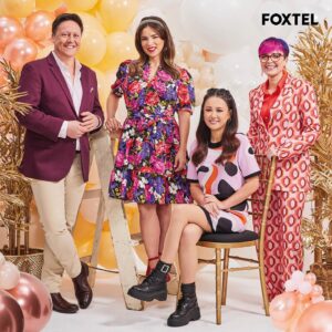 Cal Wilson Instagram - Ooooh is that the June issue of #FoxtelMagazine,arriving in homes right now? Yes, yes it is! 
And it’s only me and me beautiful bakey mates swanning about on the cover, and inside. 

I had the best time working with these three (and our twelve fabulous bakers) what an absolute treat to go to work and laugh all day. Can’t wait for you all to see it. 

#FoxtelMagazine #BakeOffSu #GABO

(Image 1: Cal in an aggressively patterned, but cheerful pink and orange suit. She is standing, arms crossed, between the letters G, B and O, her stance making her legs and body form the missing A. Also visible, how pleased she was with herself for thinking of it. 
Image 2: Four smiling people, (beautifully dressed by @elenimstyling, and delightfully prettified by @juliecooper_makeup ) @darrenpurchese, @rachelkhooks, @natalie.tran and Cal. 
Darren and Rachel are leaning on a ladder, surrounded by celebratory balloons. 
Natalie is seated on a gold coloured chair, with Cal behind her, hands resting on the back of the chair, like she might nick it once the photoshoot’s done. (She didn’t, just to be clear))