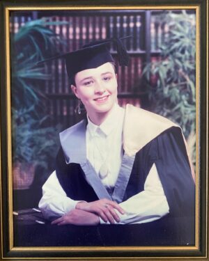 Cal Wilson Instagram - Yeah, I was a minxy University saucepot, what of it? 

#throwback

(Image: a 21 year old Cal in a university gown and mortarboard. The gown has a pink and grey drapey bit to either denote what her degree is or that she just really loves Galahs. 
She is wearing a white shirt and a big silver locket. Her hair is completely pulled back and the mortarboard is giving her a pronounced widows peak. 
Behind her is a fully fake fancy bookshelf and some plants, that are supposed to make her look learned and erudite.
Her smile is vague and inoffensive, as if she is not fully into having this photo taken. Which she wasn’t. 
Not pictured, how worried she was about getting the gown back to the hire place without getting charged a late fee)(Every now and then, she thinks about taking her glue gun to the frame, but hasn’t yet)