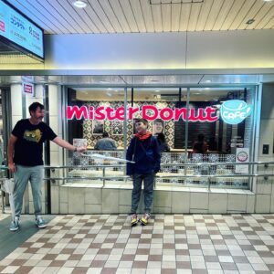 Cal Wilson Instagram - Happy Birthday, Digby. 
You are my favourite, you funny, empathetic, energetic, curious, wonderful creature. You constantly amaze and delight us. What better way to start a 14th Birthday, than donuts for breakfast in Osaka? 
(Also, how the hell are you 14 already?)

(Image: Cal’s son Digby stands in front of a Mister Donut shop, laughing, as he looks at his father who is menacing him with a furled umbrella to make him smile. Not pictured, the 100 or so donuts we’d just polished off in the cafe. Of all the beautiful things we ate/experienced/saw, it’s Mister Donut we’ll miss the most)