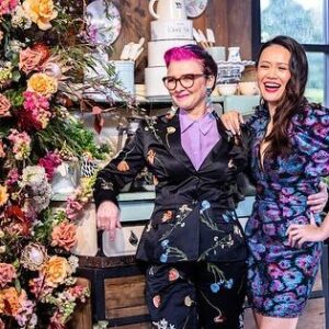 Cal Wilson Instagram - Can’t believe it’s the Finale of @bakeoffau tonight! Truly my favourite ever gig. 
The glorious @maggie_beer returns for a delightful bit of judgery, and our amazing final 3 bake their socks off. 
8.30 tonight on @foxtel and @binge 

#GABO #BakeOff #Finale #Baking #GreatAustralianBakeOff
 
(Images: 1: five smiling people, dashingly attired, stand at the front of the Bake Off Shed. @darrenpurchese, @rachelkhooks, @maggie_beer, Cal, and @natalie.tran. Cal can’t speak for the others, but she is just a little star struck by Maggie, and quite covetous of her amazing orange earrings. 

Image 2: Natalie and Cal stand smiling with their arms around each other, next to some utterly incredible foliage, in the shed. Cal is wearing a great suit, Natalie, a particularly stunning dress. They look like a fascinating power couple. 

Image 3: the reverse of the first image: the backs of our intrepid hosts and judges. It’s a sort of poignant goodbye, reflecting that this is the last episode of this season, oh god I’m not ready. 

Image 4: our mighty final 3 bakers, @ilonabakes, @lozfozbakes, and @whatsadambaking. They have their arms around each other and are standing beneath the foliage festooned arch decorating the shed. It looks so good in there, I wanted to get married again, and have the top 3 cater the  wedding That Day. 
Couldn’t be prouder of these creative, talented, generous, lovely people)