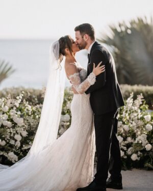 Cassie DiLaura Instagram - wedding details • part three • the ceremony 

• the kiss 😘 I laugh now at how much thought went into this moment beforehand… is everyone out of the way? do I go on the outside of your nose? where’s my arm/hand go? 😂 best part was my brother shouting “alright, that’s enough.”
• last minute decision to add rose petals to line the aisles 👌🏼 @blushnroses.cabo 
• I almost didn’t even make it to the ceremony (story for the next post 😅) but I must have taken 25 deep breaths during this “walk” and somehow managed to not get that veil snatched off the top of my head 😂  I met both my mom and dad at the bottom of the stairs too 🥰 
• 🥲 @brettlazar 🥲
•66 of our favorite people ♥️♥️♥️   @photobyjulieta & @danieljireh working their magic ✨✨
•shoutout to our free officiant!!!! thank you dad #2!!!! ♥️
•shoutout to our 2-year-old ring bearer @therealleebow 😂
•thank you @gerardodiazviolinis for the beautiful, beautiful, beautiful violin music. all of me wanted to cry but I couldn’t ruin my makeup LOL 🎻 
•2/3 of my flower girls 💐 thank you @azazieofficial for the most gorgeous dresses!!! the girls whirled and twirled all night in them 🤍
•the best photo of the wedding… dad catchin’ some 💤 because weddings are exhausting 😂

#wedding #thecape #weddingdetails #florals #weddingvenue #weddingflowers #weddingdress #weddingdecor #weddinginspo #cabosanlucas #bride #groom #weddingviolin #cabo