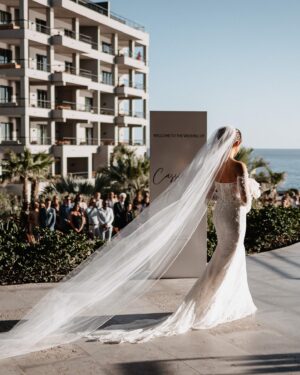 Cassie DiLaura Instagram - wedding details • part three • the ceremony 

• the kiss 😘 I laugh now at how much thought went into this moment beforehand… is everyone out of the way? do I go on the outside of your nose? where’s my arm/hand go? 😂 best part was my brother shouting “alright, that’s enough.”
• last minute decision to add rose petals to line the aisles 👌🏼 @blushnroses.cabo 
• I almost didn’t even make it to the ceremony (story for the next post 😅) but I must have taken 25 deep breaths during this “walk” and somehow managed to not get that veil snatched off the top of my head 😂  I met both my mom and dad at the bottom of the stairs too 🥰 
• 🥲 @brettlazar 🥲
•66 of our favorite people ♥️♥️♥️   @photobyjulieta & @danieljireh working their magic ✨✨
•shoutout to our free officiant!!!! thank you dad #2!!!! ♥️
•shoutout to our 2-year-old ring bearer @therealleebow 😂
•thank you @gerardodiazviolinis for the beautiful, beautiful, beautiful violin music. all of me wanted to cry but I couldn’t ruin my makeup LOL 🎻 
•2/3 of my flower girls 💐 thank you @azazieofficial for the most gorgeous dresses!!! the girls whirled and twirled all night in them 🤍
•the best photo of the wedding… dad catchin’ some 💤 because weddings are exhausting 😂

#wedding #thecape #weddingdetails #florals #weddingvenue #weddingflowers #weddingdress #weddingdecor #weddinginspo #cabosanlucas #bride #groom #weddingviolin #cabo