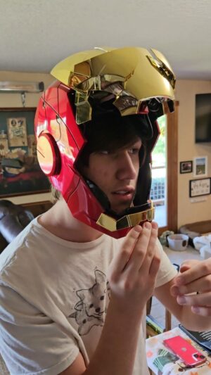 Chad Lindberg Instagram - My nephew Ivan -- @technowolffe -- is trying out his graduation gift. Iron man is his guy. This helmet is SO COOL. Congrats, @technowolffe! This is very Tony Stark of you. 🕶❤️💛 #ironman #graduation #nephew