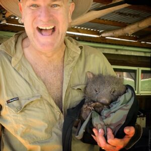Chris Bath Instagram - Imagine this little girl’s delight (I mean, look at her face) being cuddled by this giant human after we found her this morning, wandering alone & injured on our hill, then picked her up in some old towels & popped her in an esky before calling the amazing Roz and Kev from @wombatrescue who reckon she’ll make a full recovery in their care & return to our hill to have a lovely life. 🙏🏻🙌🏻