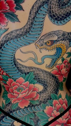 Chris Garver Instagram - I just got to finish this piece. Sasha had a tattoo that had some laser treatments on an old tattoo and it was light enough to cover without making it too dark.
#femininetattoo  #badasswomen #tattooedwomen 
#snaketattoo #peonytattoo #nyctattooartist #nyctattoo  #backpiecetattoo  #thesolidink