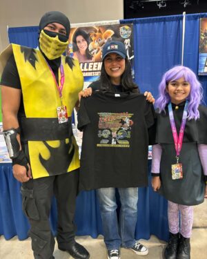 Colleen O'Shaughnessey Instagram - Thank you so much @hill_country_comicon !! ❤️

And thank you to all of the attendees and for sharing your tremendous talents with me! I received another awesome shirt by @spadedesigns_  He made me Charmy Bee!! LOVE IT! 
Thank you for the Michigan National Championship shirt from this cutie and her dad. More amazing artwork - the beautiful Wasp pic by @havoc0325 and the super cool Sonic poster in the last pic by @gilbertperezart ! 

And oh my goodness, that little girl who proves that you can be a princess and a fairy and wield an axe all at the same time!! 🧚💪