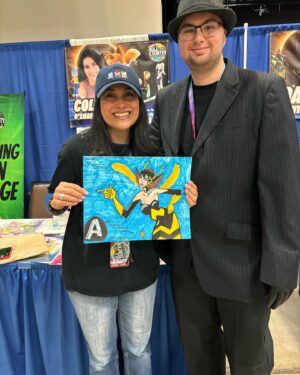 Colleen O'Shaughnessey Instagram - Thank you so much @hill_country_comicon !! ❤️

And thank you to all of the attendees and for sharing your tremendous talents with me! I received another awesome shirt by @spadedesigns_  He made me Charmy Bee!! LOVE IT! 
Thank you for the Michigan National Championship shirt from this cutie and her dad. More amazing artwork - the beautiful Wasp pic by @havoc0325 and the super cool Sonic poster in the last pic by @gilbertperezart ! 

And oh my goodness, that little girl who proves that you can be a princess and a fairy and wield an axe all at the same time!! 🧚💪