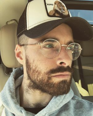 Corey Cott Instagram - Hey guys. I’m just...speechless. I’ve gotten an unbelievable amount of messages congratulating me on my beard finally extending down to my chest hair. It’s overwhelming. You guys see me. You notice me. You accept me. We. Are. One. I just wanted to humbly tell you - if I can do it, you can too. Don’t doubt yourself. The sun is your guide. Let your heart lead you down the highway. God bless the broken road because all roads lead to one destination. A beautiful collision of hair. On your mid neck area. Long hair don’t care. Let the sunshine. Get me out of quarantine.