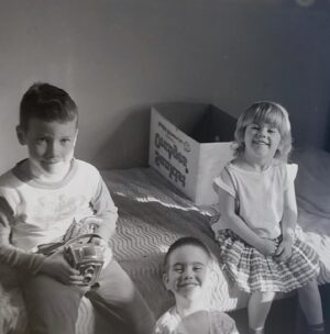 Corrine Koslo Instagram - Happy birthday big brother Chris, sitting left, brother Tim in the middle and myself. Photo taken in Halifax around ‘63.
 Happy 65 Chris!!
You are a great brother, gifted artist and photographer! Wish we could share a cup of coffee in the same room!#blackandwhitephotosofinstagram#familyphotographer#olderbrothersarethebest