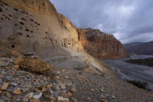 Cory Richards Instagram - Words by Ben Ayers @jetbutterflies // In the wide desert of Upper Mustang, the road planes along canyon walls and dry mountainsides dotted with hundreds of unspeakably ancient human-made caves. The light plays a slow game of chase with the shadows cast by the highest mountains on the planet, now behind us. We sweep the corners wide, drawn to cliff-edges teetering above the braided Kali Gandaki River below. We don’t know where to look – the road, the layers of tortured mountains, or the sand-castle parapets of rock and mud towering above us.
 
Instead, we watch the oncoming frame-bent jeeps as they roaring around the blind corners on bald tires. In Tsarang, the drivers share a rough kindness with us. We play snooker, a game we don’t know. Cory tries and fails to find a tutorial on YouTube. Nursing warm cans of beer, we realize the drivers don’t know how to play either.
 
The evening passes in one long, impossible game of scratches and flubs until the young man running the hall flicks the light switch and kicks us out into the cold, thin air of a star-streaked night.  @vacheronconstantin