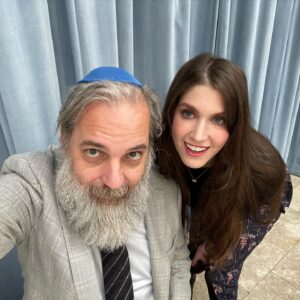 Dan Harmon Instagram - Bro in law and fellow gentile spy @danvidetich helping me make yarmulkes look rugged at Cody’s cousin’s kid’s bar mitzvah. This isn’t the party part. Just the coffee part after the official holy part. Never seen anything like that ceremony. Pure chaos. Cantor took a piece of candy to the head. Rabbi is a big Community fan but can’t be photographed until sundown or he’ll turn into a wolf (I think I’m getting that right). Little Maya with Aunt Cody. Now time to rest so we can drink a hundred tweens under the table. Shabbat Shalom Ross and Zac thanks for inviting us