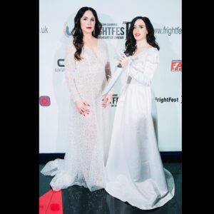 Danielle Bisutti Instagram - “The Blue Rose premiered at London FrightFest and brought otherworldly glamour to the red carpet.” 💙 🌹 

This is just the beginning… 👁️🩸🔪 

📸 @imago.images @alamyltd 
👗 @azazieofficial @michelemariepr 
💍 @pr_solo 
💄 @maccosmetics 
💋 Hair & Makeup @jolandamakeup 

The Blue Rose Red Carpet Credits: 
Written, Directed & Starring - George Baron @sp00kyge0rge 
Produced by Athena Pictures 
@sarena15 @andrapaigegordon 
Line Producer - Nicole Flores 
Cast:
George Baron - “Dalton”
Danielle Bisutti - “Norma Steele”
Nikki Austen Smith - “Sophie”
@nikkoausten 
Sophie Cooper - “Delilah” 
@sophieclarecooper 

Rebecca - “Norma Steele Cosplay” 🔪 💋 
@rebeccacosplaysladyd 

Diana Ferrare-Magaldi - “My mom”💕💝💕
@dianaferraremagaldi 

Thank you to @frightfestuk @clout.pr @icon_pr @joeygirard @bohemiagroup_ @torirobertson__ 

#thebluerose #worldpremiere #normasteele #femmefatale #london #frightfest #indiefilm #redcarpet #filmnoir #surrealism #vintagestyle #actorslife #filmfestival #glamour #azazie #azaziebridalgowns 🤍