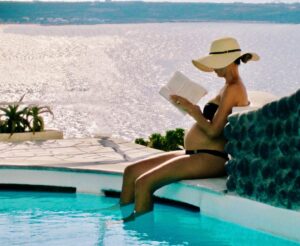 Danielle Demski Instagram - I missed #bumpday last week, because who has time to remember bump day when you have two kids🤪
So here’s a throwback to the days when there was a baby in my belly and I had quiet time to sit and read a book by myself😉📚🌈 
.
Nowadays things are a lot busier in my world with a 4 year old and a 1 year old! Not much quiet time alone, but honestly, I’m enjoying the noise❤️
.
.
.
.
.
#bumpday #tbt #momlife #greece #santorini #pregnant #babybump #travel #babymoon #roomwithaview