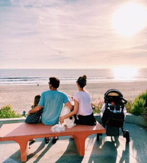 Danielle Demski Instagram - Sunsets looking extra magical these days🌈✨👨‍👩‍👧‍👦🐶
.
After weeks of closures, our beaches are finally open again! We’re still trying to be careful by wearing a mask and social distancing, but it feels so good to put my feet in the sand and see the waves❤️
.
.
.
#beachlife #fridayfeelings #calilove #family #togetheralone #manhattanbeach #sunset #newborn #momlife