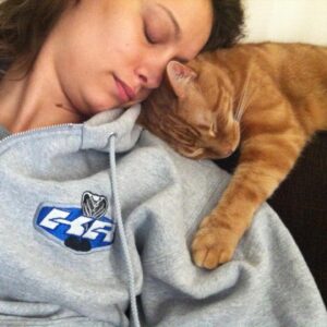 Deanna Russo Instagram - I know death doesn’t give warnings but, boy, does it have a sense of humor. The last words I said to my cat were, “Just go and die already.” Maybe the full moon last night did have as much power as all the astrologers said it would because my words came true. My orange bastard of a cat went and died already. 

He was old and had just pissed on the rug. I was mad so I shoved his nose in his mess and then put him outside, which wasn’t really a punishment. He loved going outside. He had cultivated several names in the many homes he frequented, but in my house, he was The Dude. 

The Dude would abide, but he also had strong opinions about the company I kept. He never warmed up to the kids. I think he considered himself my primary partner and didn’t like sharing my attention. He’d piss in your shoes or shit on your head while you slept if he didn’t want you around. He stood at the helm of my romantic life, the bastard. 

One day while shopping for protection dogs, this determined orange kitten crawled up my pant leg and didn’t leave me alone for the next 15 years. He earned the name because that’s what I shouted every time he charged at his reflection in a floor mirror, cracking his skull against the silver glass, “Dude!” It just stuck. 

The Dude and I were so closely connected before I became a human-mom that I would hold him and sob at the thought of him dying one day. And now that day is today. It was very un-dude of him to piss on my rug because yes, it really did tie the room together, but he did take his own exit, which is something he knew I wanted.