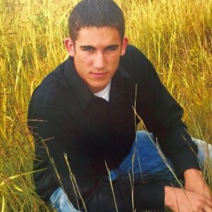Derek Peth Instagram - Hahaha Soooo tough in my pooka shell necklace and a white undershirt under a black dress shirt while I’m crouching on some random farmer’s property. Senior pictures are always good for a laugh.