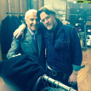 Donal Logue Instagram - Digging through a storage locker on my ranch in Oregon last week, I cracked open an old cardboard box and found plunder. Stuffed in a trash bag was a suit I thought I'd lost forever. I immediately thought of the man who made it, Martin Greenfield. I met Martin in Brooklyn in 2014 after I was given a time and address in East Williamsburg for a "Gotham" fitting. 
I climbed to the third floor of a rundown warehouse and finding nothing other than some discarded cardboard boxes and a broom lying curiously in the middle of the floor, turned to leave when I heard voices coming from behind a doorway. I followed them and entered a world as mind-blowing as Wonderland. On every wall hung bolts of beautiful fabric in every conceivable color and pattern-- tweeds, wools, silks. A man on a phone behind a counter gave me a "one-minute" finger gesture and I turned to study the room. Tucked between reams of cloth, I noticed a series of photographs of a man with a tape measure standing with Presidents Eisenhower, Ford, Nixon, and Obama. A hand tapped my shoulder. I turned and found myself looking at the coolest-dressed octogenarian I'd ever seen. I pointed to the pictures. "That's you!" I said. He nodded. "Wow," I said. "I bet there could be an amazing history of American political life told through the eyes of the man who dressed the presidents." 
“My story is much deeper than that,” said the man. 
We stared at each other a few beats and I asked him, "What camp were you in?" 
“Auschwitz and Bergen-Belsen," he said. He rolled up his sleeve, revealing a numeric tattoo. For the next hour and a half, the man told his story of survival. I can't do it justice here, but please seek out the book "Measure of a Man: From Auschwitz Survivor to Presidents' Tailor" to read for yourself. Martin and I became friends that day. Before I left, he said, "Please, let me make you a suit. Not for the show, for you." It's the suit I'm wearing in the pic with my "Gotham" castmates (and the one I found in a box in a storage locker in Oregon). Martin Greenfield-- legend and one of the last of the golden generation. I haven't spoken to him in a couple of years, but he's been on my mind a lot lately.